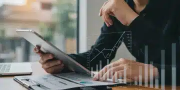 Person analyzing credit report on tablet for score improvement