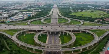 Modern highway interchange with multiple lanes and overpasses, representing the future of US transportation infrastructure.